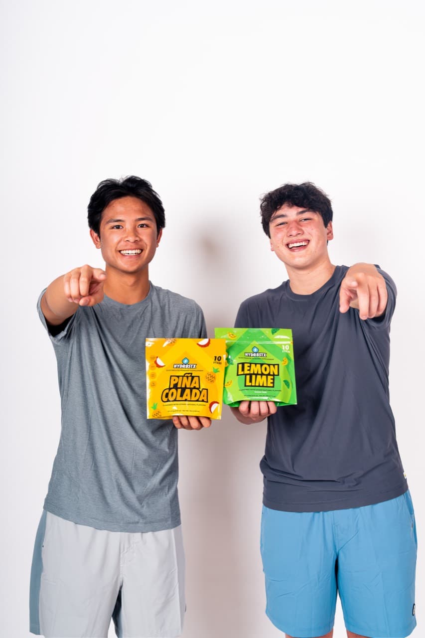 Hydr8Stx co-founders holding Piña Colada and Lemon Lime pouches