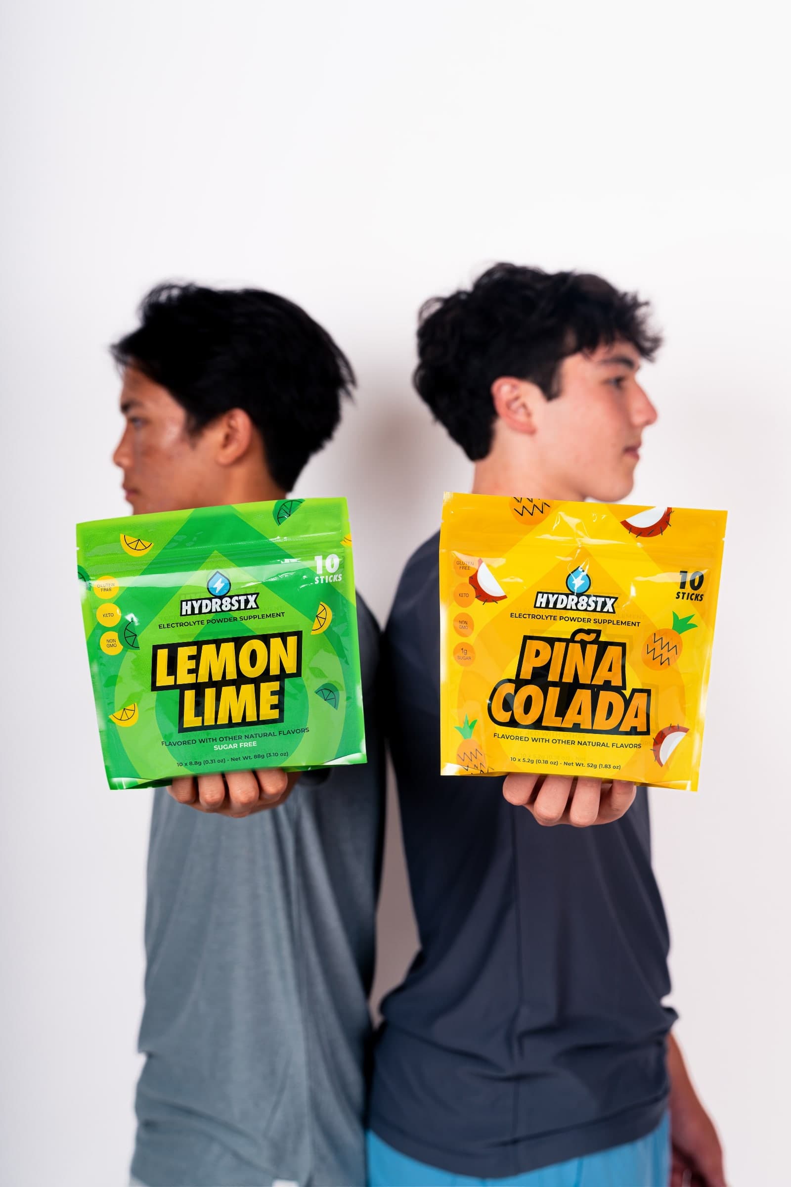 Hydr8Stx founders holding Lemon Lime and Piña Colada pouches