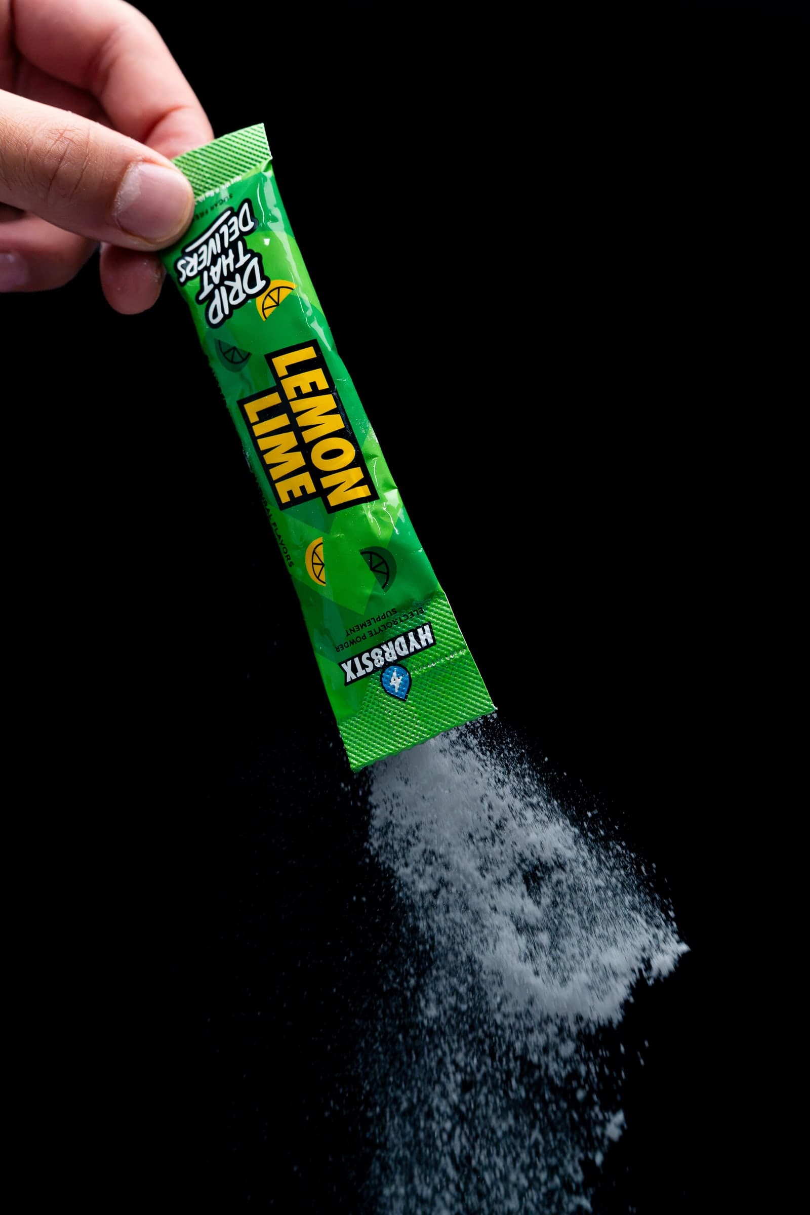 Lemon Lime Hydr8Stx powder pouring from a single-serve stick