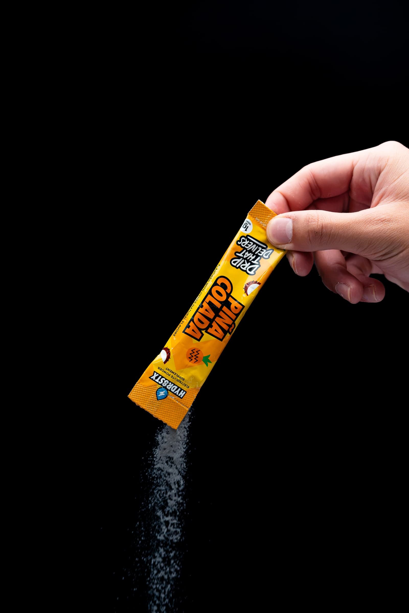 Piña Colada Hydr8Stx powder pouring from a single-serve stick