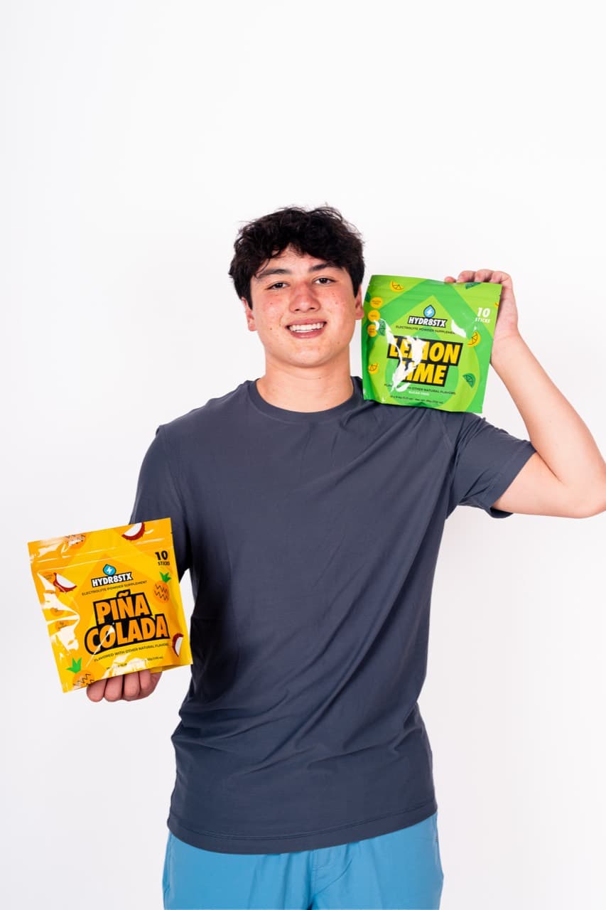 Dominic holding Hydr8Stx Piña Colada and Lemon Lime pouches